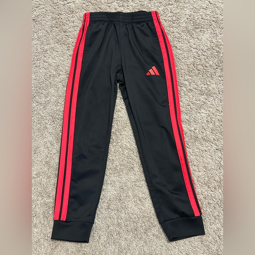Black sweatpants with red side stripes